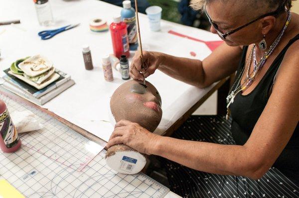 Painting the head for a sculpture project.