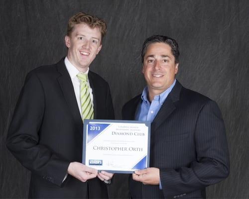 The President of Coldwell Banker Hearthside presents an award for his achievements in 2013.