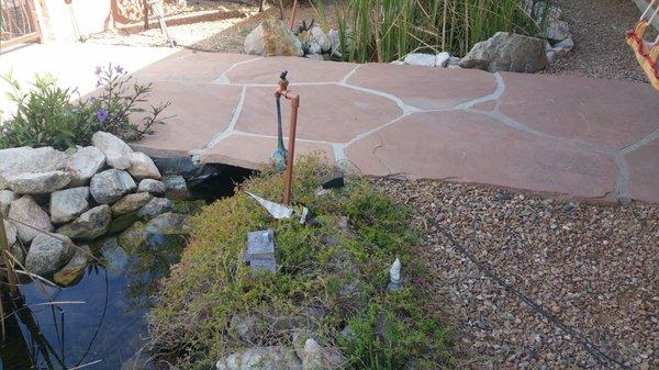 Flagstone bridge over pond