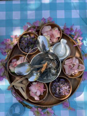 Fresh rose petals and mortar and pestle.