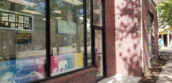 Our new location on 12th Ave! DESCRIPTION: front door and window of Perfect Copy & Print with brick façade on the right.