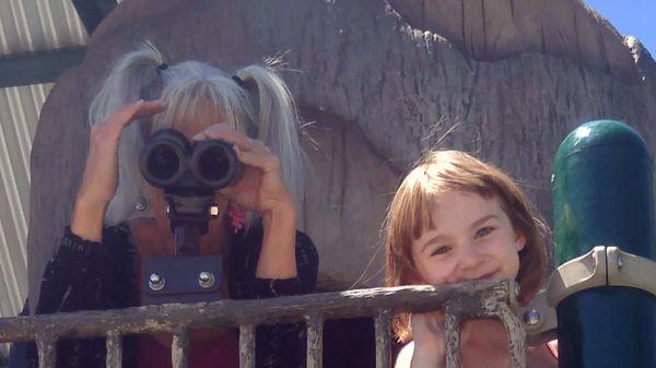 Zona and Emalynn looking thru binoculars at Memorial Park in Colorado Springs