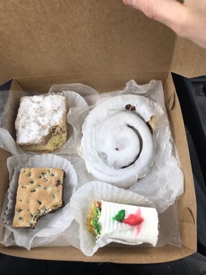 Frosted cinnamon roll ($2.25), chocolate square (around $2.25), crumb cake (around $2.50), Russian tea cake (around $2.50)