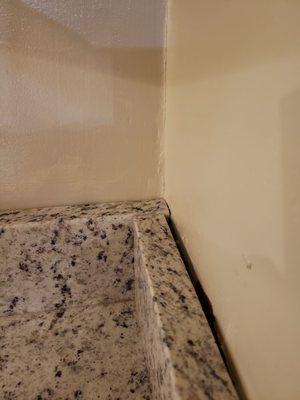 Backsplash aligned incorrectly and there was no sealant to hold in place