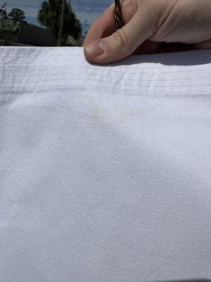 Marks that were pressed into a gi that was clean when brought to the business