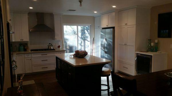 Full wall of custom pantry and storage cabinets.