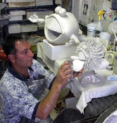 Artist Tony Longo working in the studio making a fun Frog in Santa Barbara.