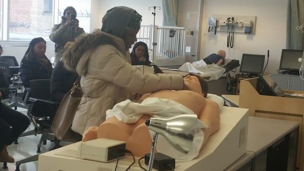 My students getting a hands on experience with the mannequin