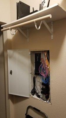 Networking Cabinet with modem and router above. All neatly hidden in a closet.