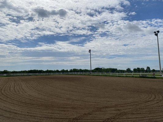 100x200 outdoor riding arena with bleachers and overhead stadium lighting