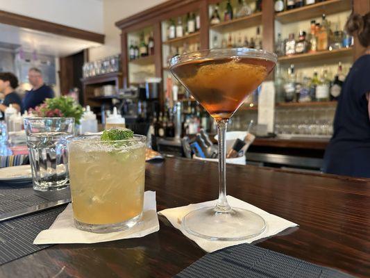 Two seats at the bar, a Manhattan (on the right), and a No See Um mocktail (on the left).