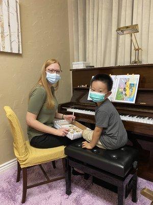 Lewis and Ms.Madison during a piano lesson