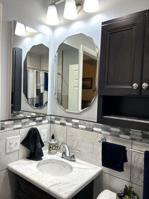 Recessed mirrored cabinet , beveled edge mirror over vanity and hickory over the John partially recessed cabinet in shale stain