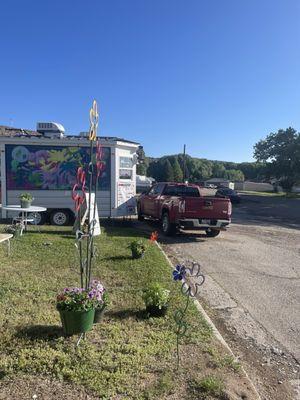 Side view of trailer with yard decorations. Trailer is facing east for drive up.