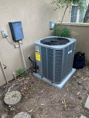 InverterCool Heat Pump Condenser Unit installed in a single-family house