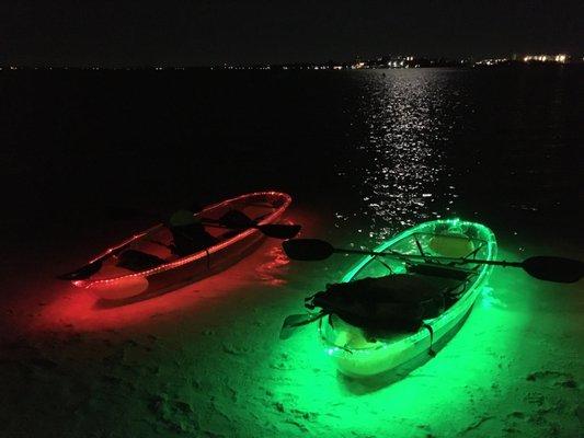 Glow in the dark kayaks on an island