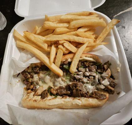 Philly cheesesteak & fries. Onions, peppers, and mushrooms. Juicy!