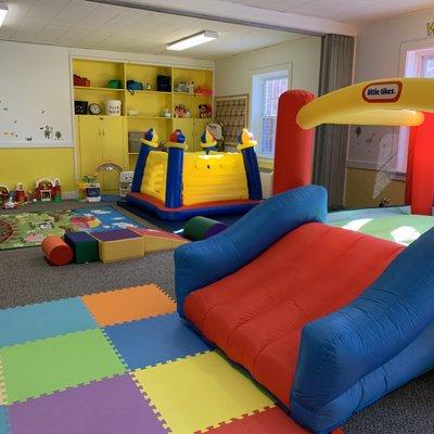 Two smaller bounce houses and lots of toys to choose from in this room.