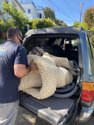 Rug was returned filthy and crammed (not rolled) in the back of this dirty car.