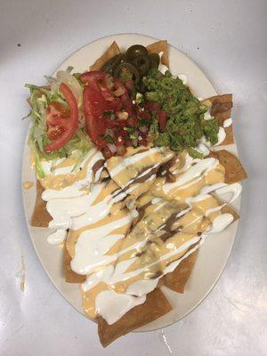 Nachos combination on meats and our recipe secret of chile c/ queso