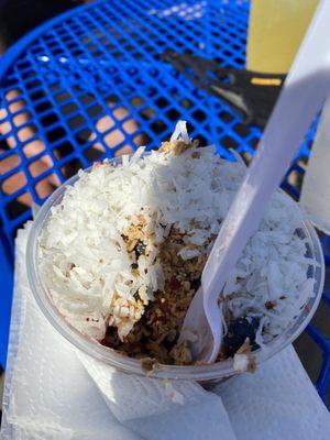 Açaí bowl - Açaí, strawberries, blueberries, frozen pineapple, peanut butter, granola, honey, coconut on top.