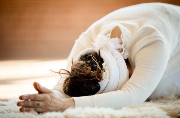 kundalini yoga and meditation student bowing after class