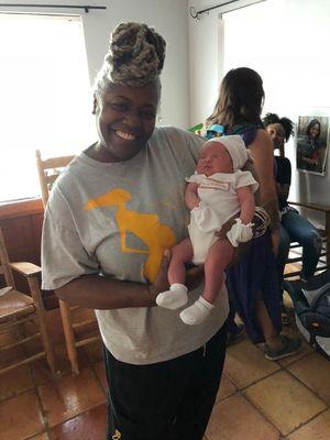 This is Afua holding our healthy 8lb 6oz baby boy.