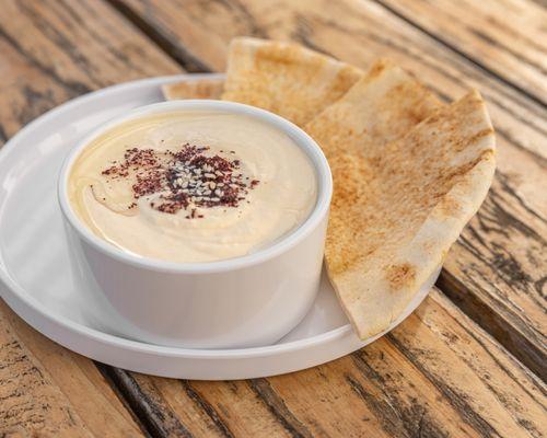 Hummus:
This savory dip is made from mashed garbanzo beans blended with sesame oil, and lemon juice. Served with Syrian pita bread.