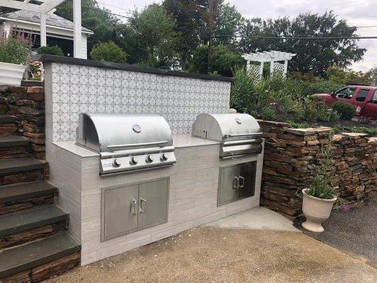 Outdoor kitchen install and re-installation of retaining wall stone.