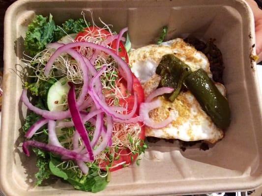 Lentil Quinoa Patty on a Kale Salad with Sprouts, Onions, Tomato, Lettuce, Grilled Pepper and a Baked Egg