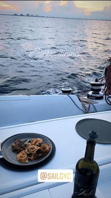 Having a sunset dinner while sailing past the Florida coast on Genesis!