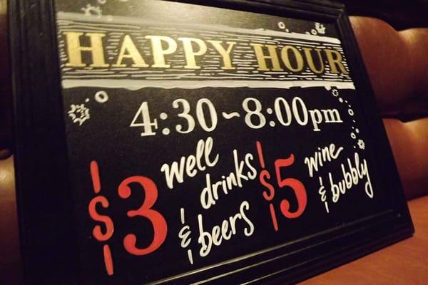 Happy hour sign outside.