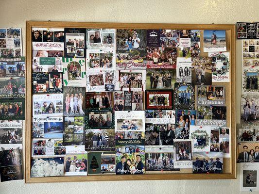 Xmas card photo wall, lots of smiling faces.