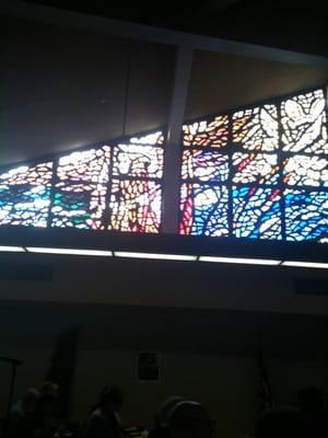 The sun shines through the beautiful stained glass windows