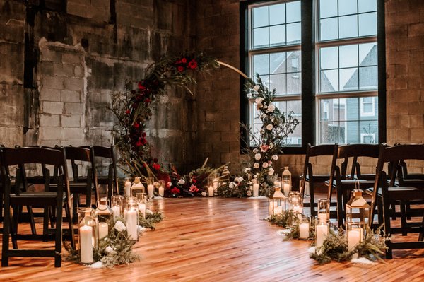 Winter wedding archway with candles at Olio modern industrial event space north of Boston Massachusetts, New England