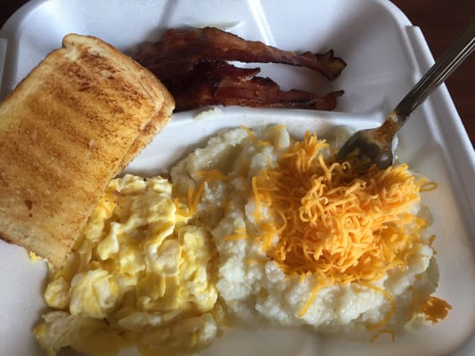 Breakfast for under $5. Grits, bacon, scrambled eggs and toast. I added cheddar cheese at home! It was quite about a tasty meal.