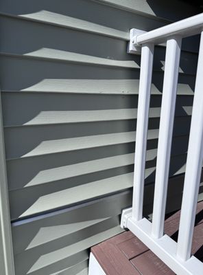 Loose siding, rails attached improperly.