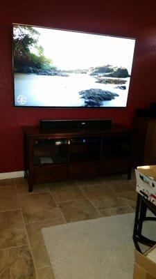 65" TV mounted with wires concealed inside the wall