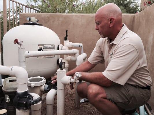 Larry inspecting pool equipment