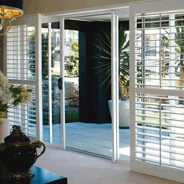 Beautiful 3 /12" louver shutters on a bi-pass track overlooking a patio and back yard.