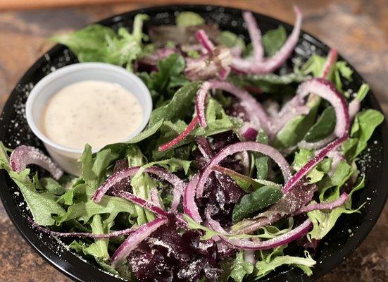 The Caesar Salad Fresh Mixed Greens, Red Onion, Parmesan Cheese and Caesar Dressing. *Add Chicken for $2 more