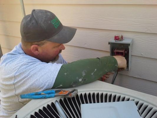 Mark, our lead installer, checks the electricity to the outdoor