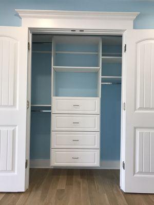 Reach-in closet with French doors.  4 x 8" Drawers with profile fronts, double hanging, and long hanging sections.