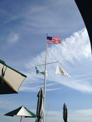 Flags outside the club house, on the grill deck.