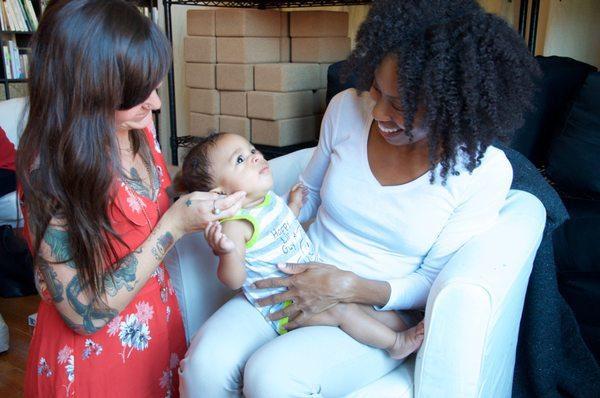 Mom holds her baby during a gentle CST treatment