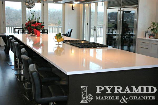 This kitchen features white quartz. What a clean look!