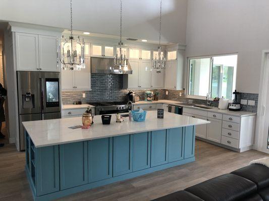 White kitchen with beautiful custom color island and quartz countertops