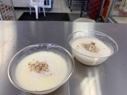 Tiny cups of delicious milk pudding topped with finely shaved coconut and possibly almonds.