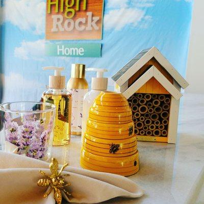 Bee themed home goods include a bee house for the garden, honey Lavender lotion and handmade, napkin rings and glassware.