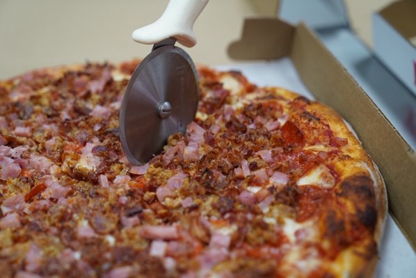 Our Meatza pizza, topped with pepperoni, sausage, ham and bacon!